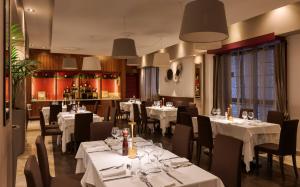 a dining room with white tables and chairs at Le Fontane del Re in Caserta +37 photos