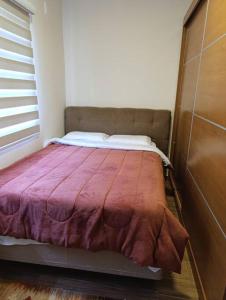 a small bed in a room with a window at Residencial Luce Del Sole - Apto N º 1 in Joinville
