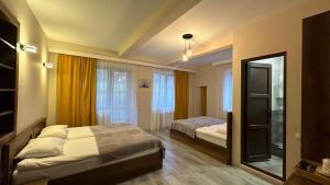 A bed or beds in a room at Hotel Axien Kazbegi