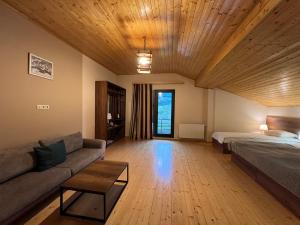 A bed or beds in a room at Hotel Axien Kazbegi