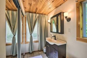 a bathroom with a sink and a mirror at Whispering Woods Cabin - Creekside & Pet Friendly in Grafton +34 photos