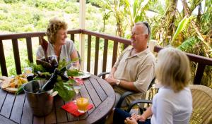 a group of people sitting around a wooden table at Governors Lodge Resort Hotel in Burnt Pine