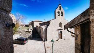 a church with a car parked in front of it at Grande maison en Ardèche in Chalencon