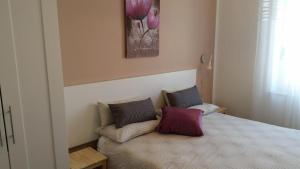 a bedroom with a bed with two pillows on it at Palazzo Garibaldi in Spoleto +10 photos