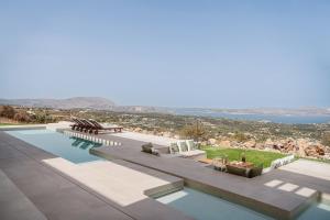 a swimming pool with a view of the ocean at JK's 4 in Vamos