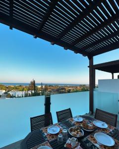 a dining table with a view of the ocean at Southern Dreams Apartments in Gennadi