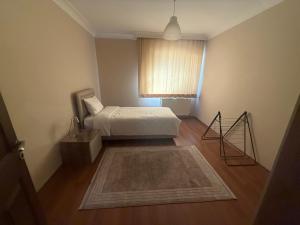 a small bedroom with a bed and a window at Corner splash in Ankara