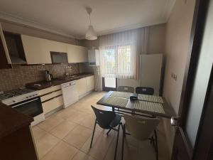 a kitchen with a table and chairs in it at Corner splash in Ankara