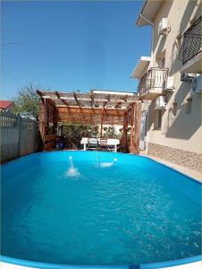 a swimming pool in the middle of a building at ROMSIL GUESTHOUSE in Costinesti