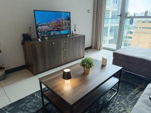 a living room with a television and a coffee table at Skynest Residences by Lisa's Paradise in Nairobi
