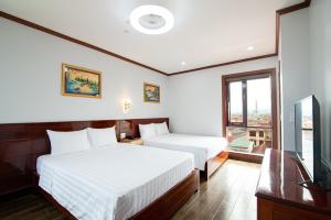 Postel nebo postele na pokoji v ubytování Minh Quang Hotel + 24 fotografií
