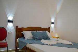 a bedroom with a bed with two lights on it at VIP next TIME Casa Vacanta in Costinesti
