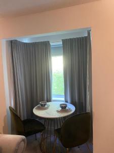 a room with a table and chairs and a window at Nw2 Studio Flat mins to London in London +13 photos