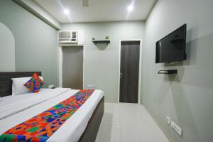 a bedroom with a bed and a flat screen tv at Via Alpha in Gurgaon +20 photos