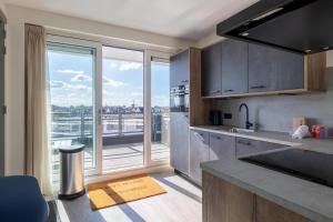 a kitchen with a view of a balcony at Vakantiewoning aan het water - met 2 balkons - Vista Maris - Nr 52 in Sint Annaland