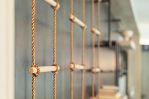 a close up of a stair case with a rope railing at Holiday Inn - the niu, Yen Hamburg City by IHG in Hamburg