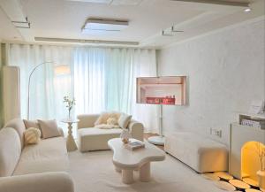 a living room with a couch and a table at Yeon Stay in Seoul