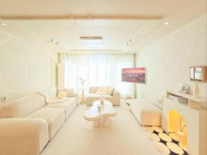 a living room with a couch and a table at Yeon Stay in Seoul