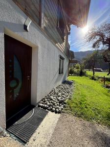 a door to a building with a grassy field at Agora in Samoëns