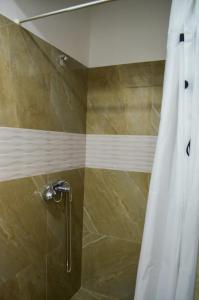a shower with a white shower curtain in a bathroom at VIP next TIME Casa Vacanta in Costinesti