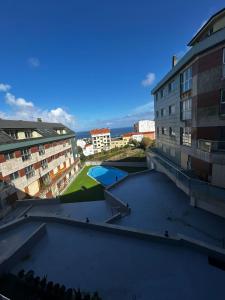 a view from the roof of a building with a pool at Malpica Beach in Malpica