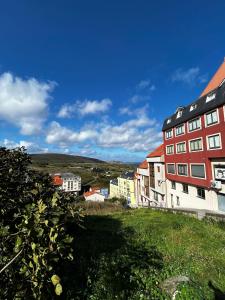 a group of buildings on top of a hill at Malpica Beach in Malpica