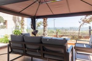 a patio with a bench and an umbrella at Marina Sea View Appartements in Casablanca