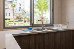 a kitchen counter with a sink and a window at Marina Sea View Appartements in Casablanca +87 photos