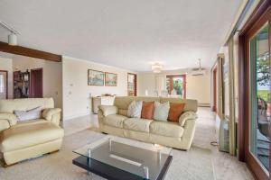 a living room with a couch and a table at Tenth of a Mile Walk to Boat Meadow Landing in Eastham