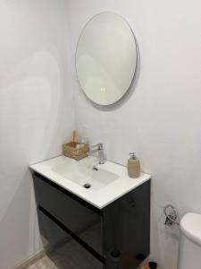 a bathroom with a sink and a mirror at CORNELIAS HOME TC3 Atico in Los Cristianos