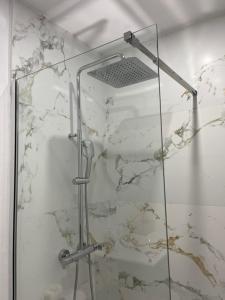 a shower in a bathroom with a marble wall at CORNELIAS HOME TC3 Atico in Los Cristianos