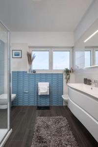 a bathroom with a tub and a toilet and a sink at Villa Milagros in Kožino