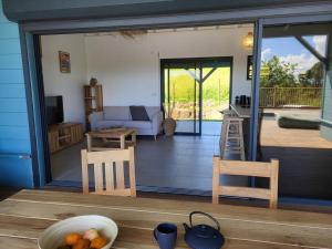a living room with a sliding glass door and a patio at SALTY LODGE Villa 3 chambres piscine "ALIZES" - Pointe Faula in Le Vauclin
