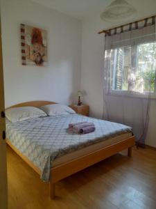 Postel nebo postele na pokoji v ubytování Apartments Jere