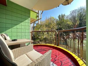 a balcony with a chair and a table on a balcony at Sarajevo center in Sarajevo
