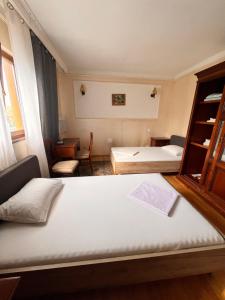 a small room with two beds and a window at Pensiunea La Palia in Iaşi +33 photos