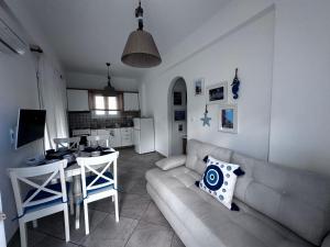 a living room with a couch and a table at Mare Monte Suites 2 in Parasporos