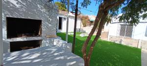 a house with a fireplace and a green yard at La Jordana 39, Calblanque in Las Barracas