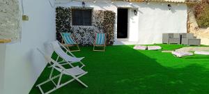 a green yard with chairs and a house at La Jordana 39, Calblanque in Las Barracas +37 photos
