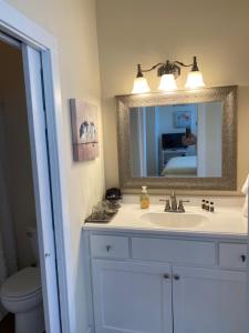 a bathroom with a sink and a mirror at The King's Daughters B and B on the Bluff overlooking the Mighty Mississippi in Natchez +19 photos