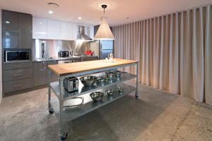 a kitchen with a stove top oven and a counter top at Zara Tower – Luxury Suites and Apartments in Sydney