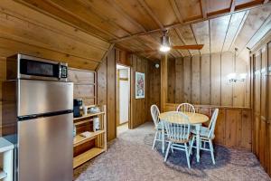 a kitchen and dining room with a table and chairs at The Manatee Cove - Side B: Studio in Cocoa