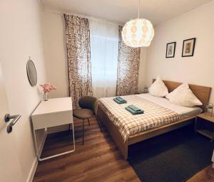 a small bedroom with a bed and a table and a window at Hanse-Vermietung in Bremen