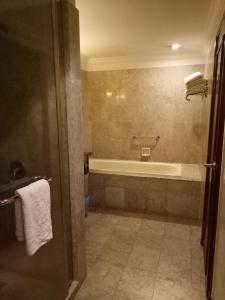 a bathroom with a tub and a toilet and a sink at Best Apartment Suite At Times Square KL in Kuala Lumpur