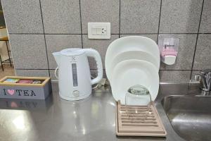 a kitchen counter with a coffee maker and a mixer at Departamentos aćawaia in Ushuaia