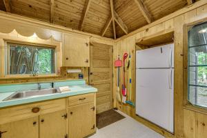 a kitchen with a sink and a white refrigerator at Rustic Cabin w/ Squam Lake Access & Fireplace! in Holderness +28 photos