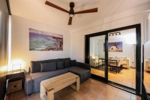 a living room with a couch and a table at HolaOla HighClass Townhouse in Lajares