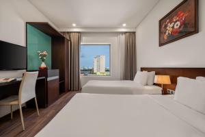 Katil atau katil-katil dalam bilik di Mitisa Hotel Da Nang - Near Dragon Bridge