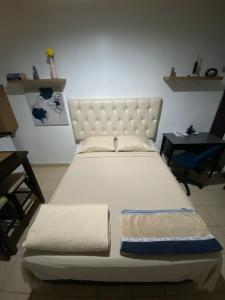 Ένα ή περισσότερα κρεβάτια σε δωμάτιο στο Suite Noa Apartamento