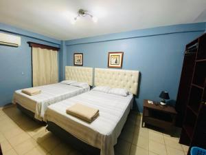 Ein Bett oder Betten in einem Zimmer der Unterkunft Merendon Suite Apartamento